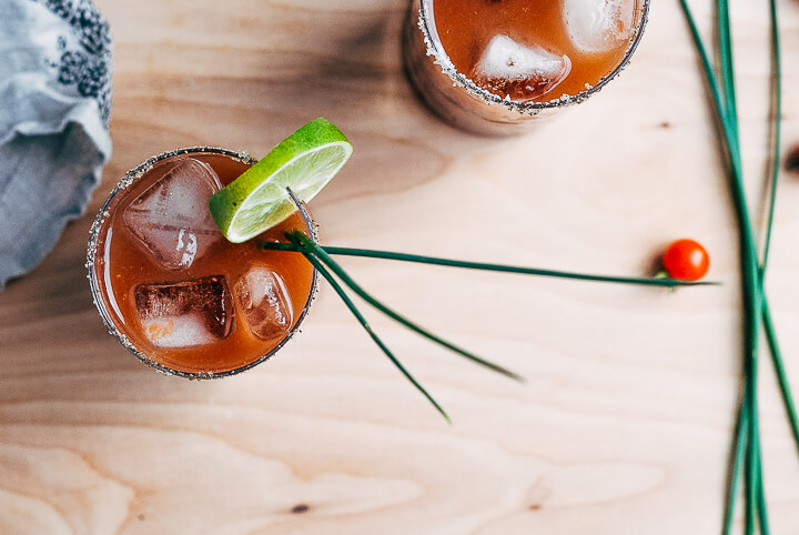 Garnish fresh tomato Bloody Maria cocktails with lime slices and fresh chives. 