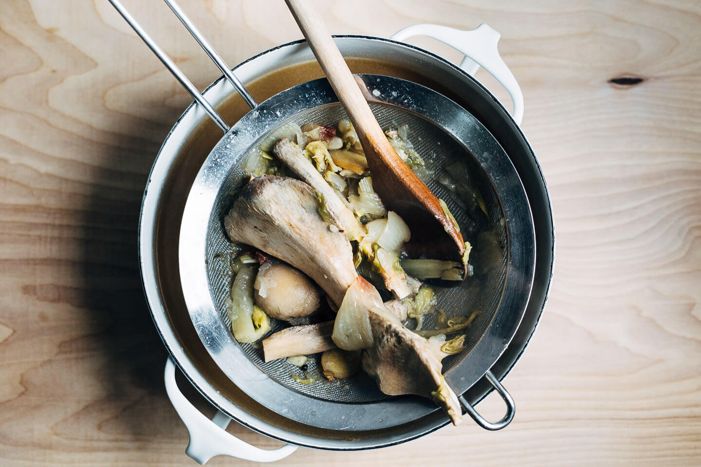 Straining pork bone broth. 
