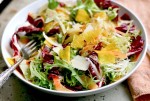 Seared cippolini onions lend depth to this jewel-toned radicchio and frisee salad with shaved beets and carrots.
