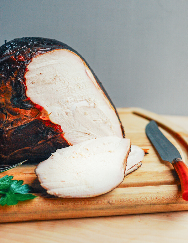 Slicing the turkey breast on a cutting board. 