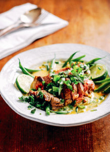 A bowl filled with lamb and green bean stew.