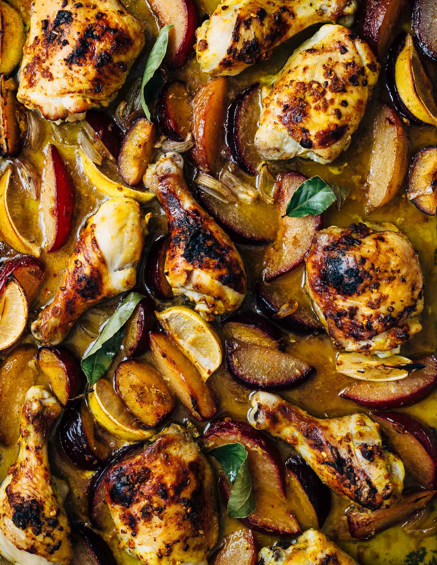 A simple sheet pan chicken and plums recipe featuring crispy saffron- and garlic-infused chicken topped with a sweet and savory plum pan sauce.