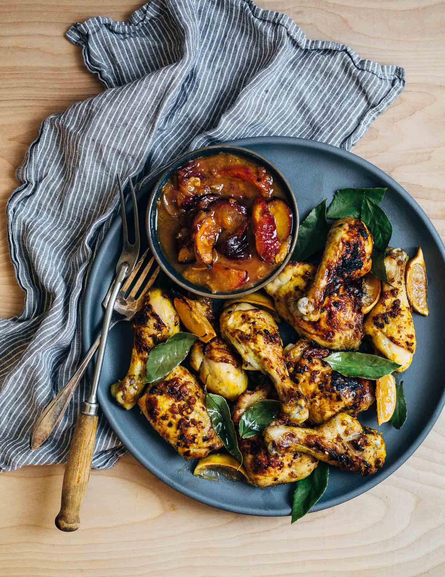 A simple sheet pan chicken and plums recipe featuring crispy saffron- and garlic-infused chicken topped with a sweet and savory plum pan sauce.