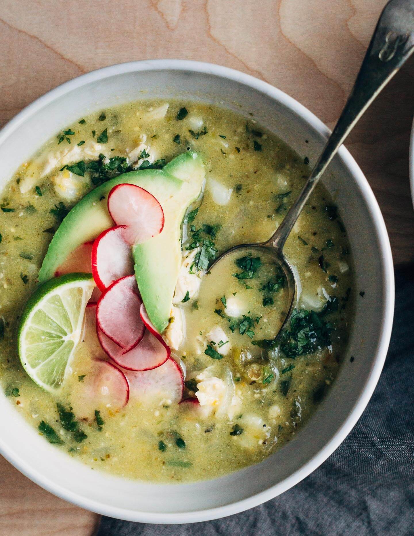 A fortifying mix of rich chicken broth, tender shredded chicken, chewy corn hominy, and tart tomatillos make this chicken pozole verde the ideal dish to see you through the end of winter (and cold season).