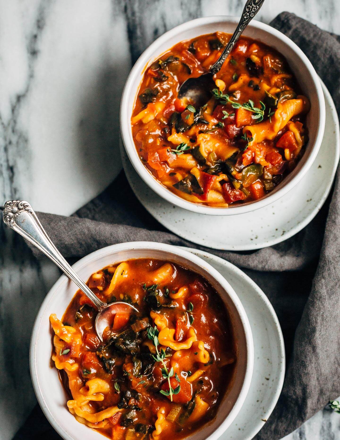 A meal-worthy vegan vegetable pasta soup with a little bit of everything: delicious vegetable broth, fire-roasted tomatoes, kale, carrots, thyme, and toothsome pasta.
