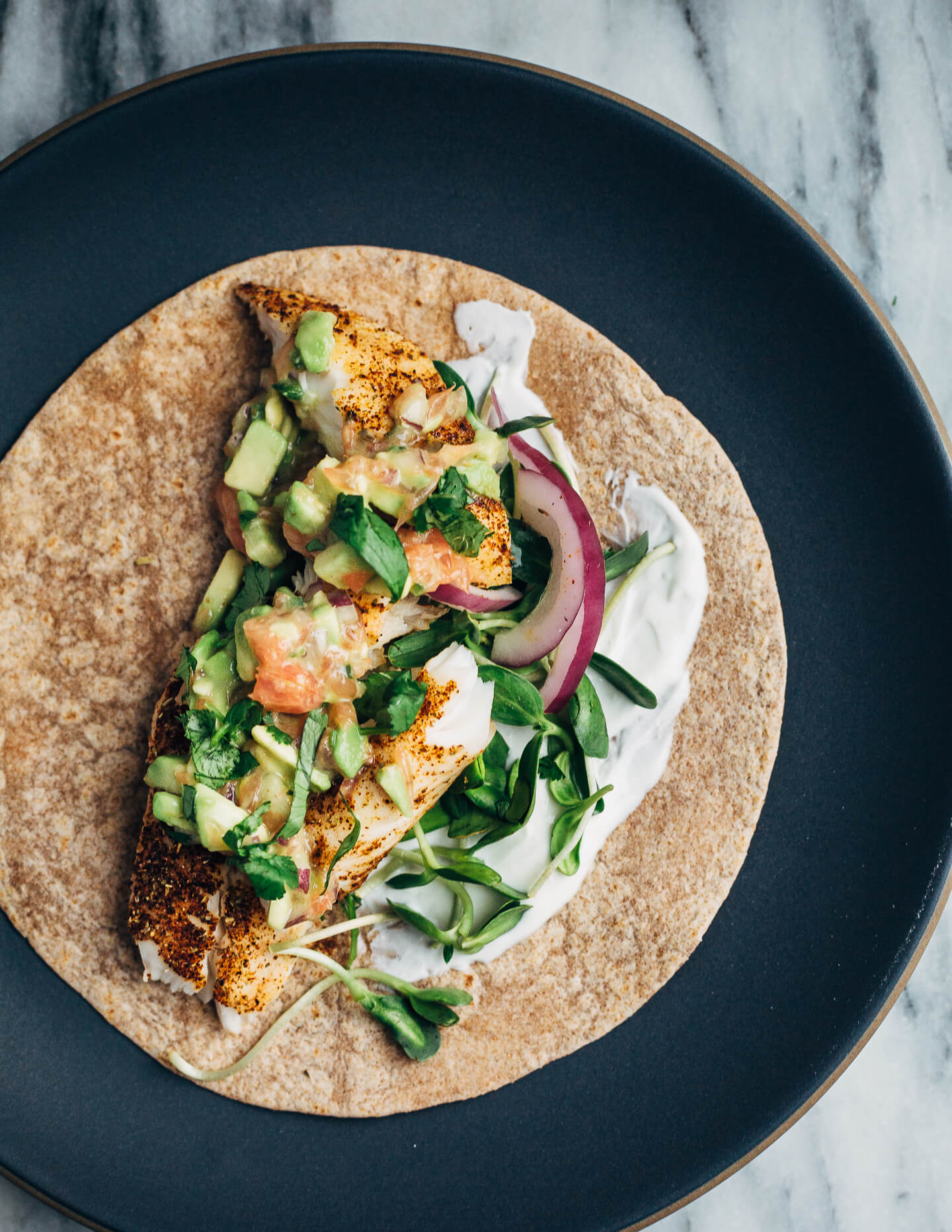 Simple broiled tilapia tacos that come together quickly under the broiler, making them perfect for weeknight meals. The tacos are topped with a tangly grapefruit-avocado salsa that contrasts beautifully with the spicy fish. 