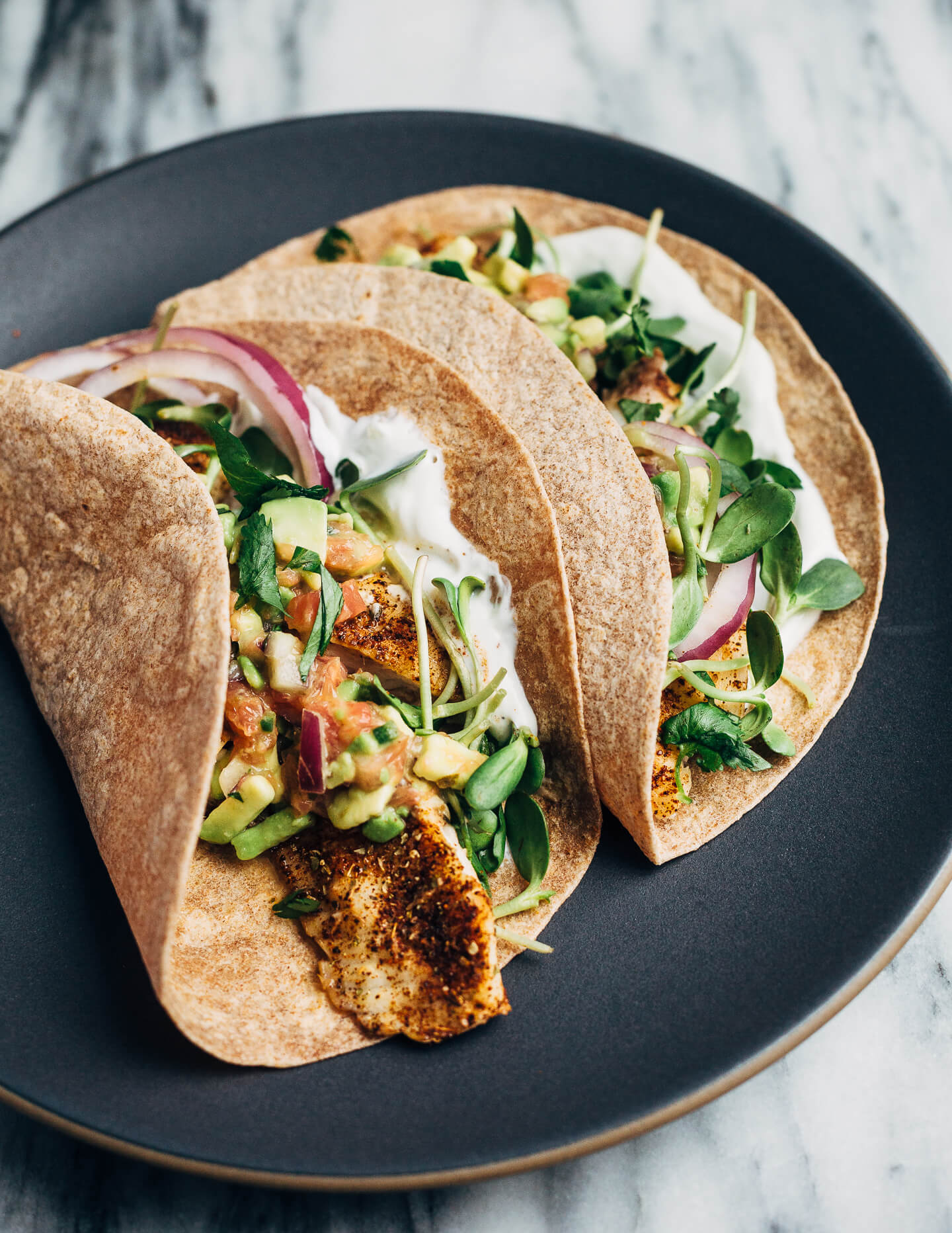 Simple broiled tilapia tacos that come together quickly under the broiler, making them perfect for weeknight meals. The tacos are topped with a tangly grapefruit-avocado salsa that contrasts beautifully with the spicy fish. 