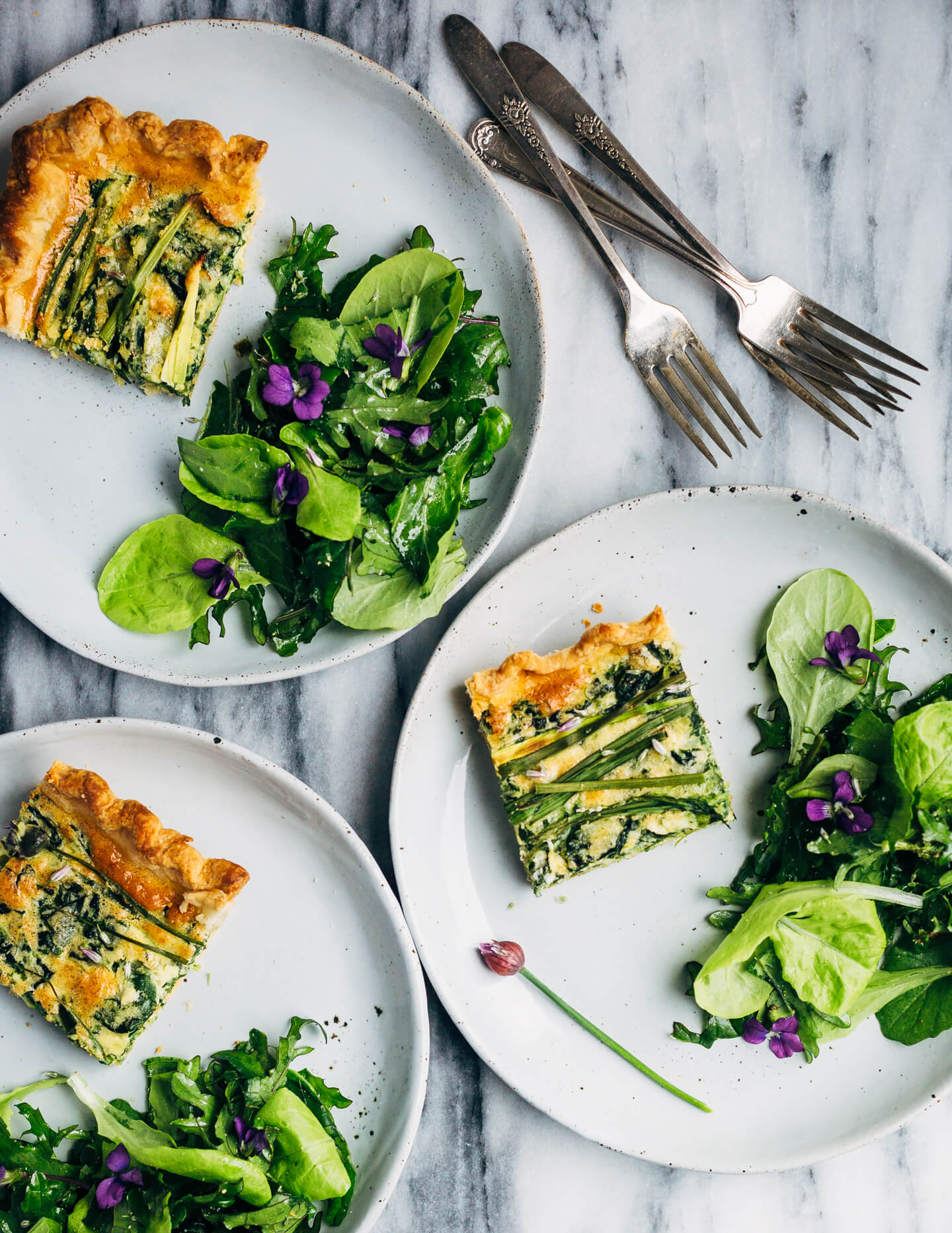 Ideal for Mother's Day brunch or spring gatherings, this sheet pan spinach quiche, made with ramps, green garlic, and chives, is a delicious way to feed a crowd.