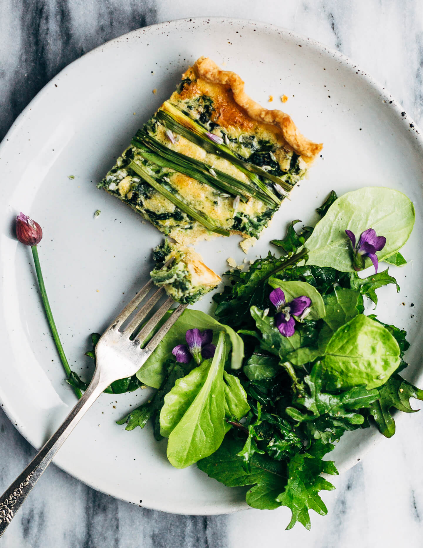 Ideal for Mother's Day brunch or spring gatherings, this sheet pan spinach quiche, made with ramps, green garlic, and chives, is a delicious way to feed a crowd.