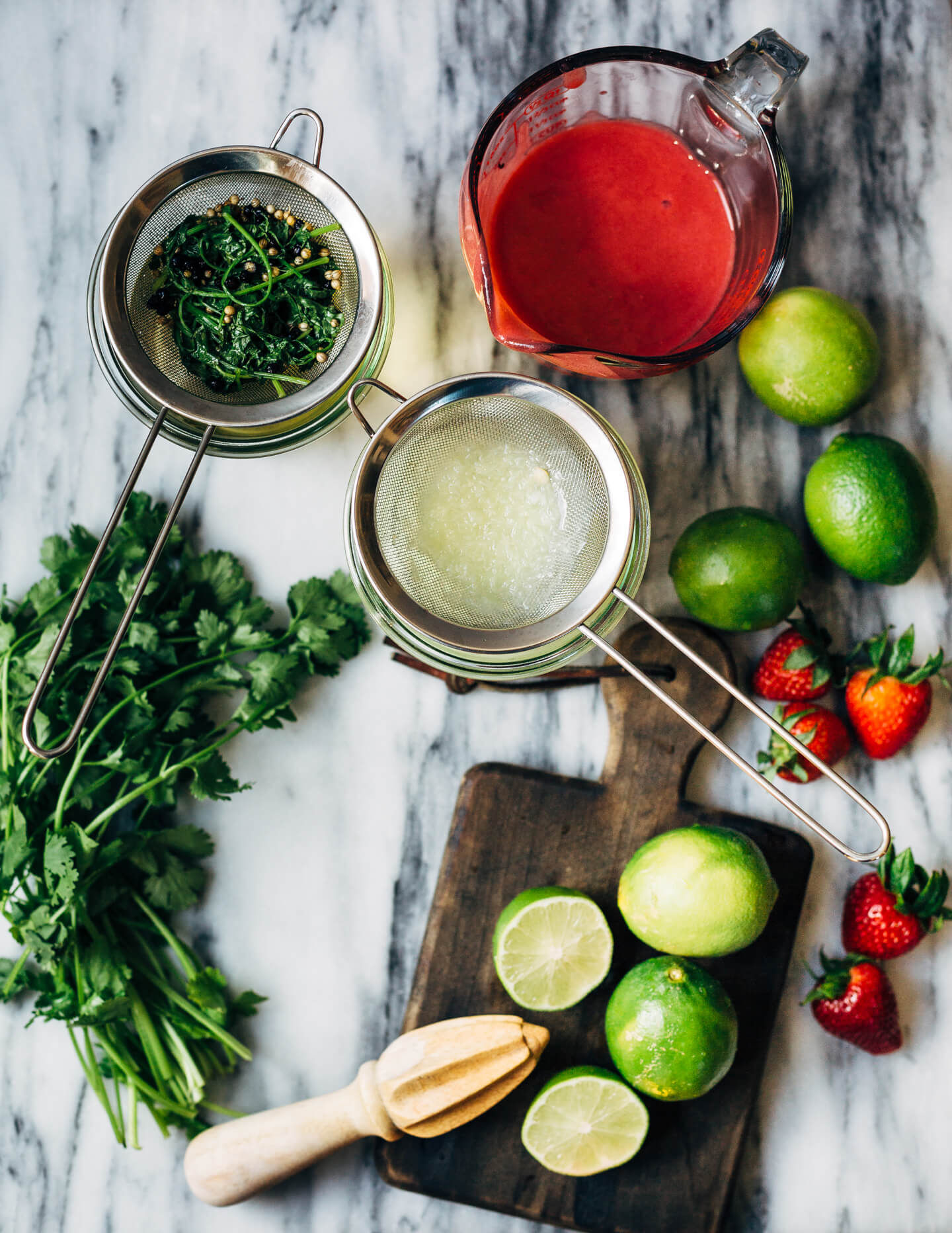 Pretty pink strawberry margaritas blended with an herbaceous cilantro, coriander, and black pepper simple syrup. These fresh strawberry margaritas are beautifully balanced and totally refreshing. 