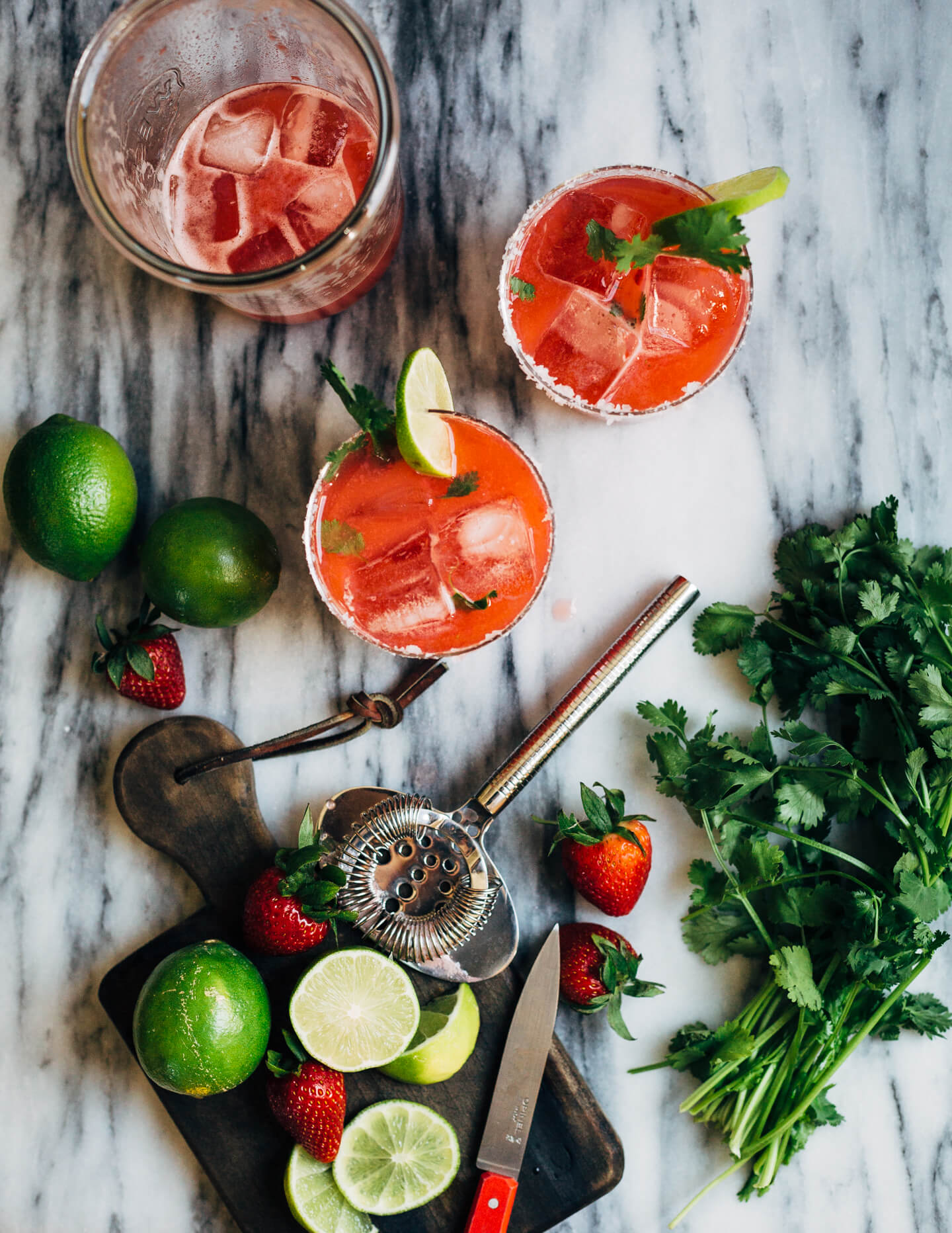 Pretty pink strawberry margaritas blended with an herbaceous cilantro, coriander, and black pepper simple syrup. These fresh strawberry margaritas are beautifully balanced and totally refreshing. 
