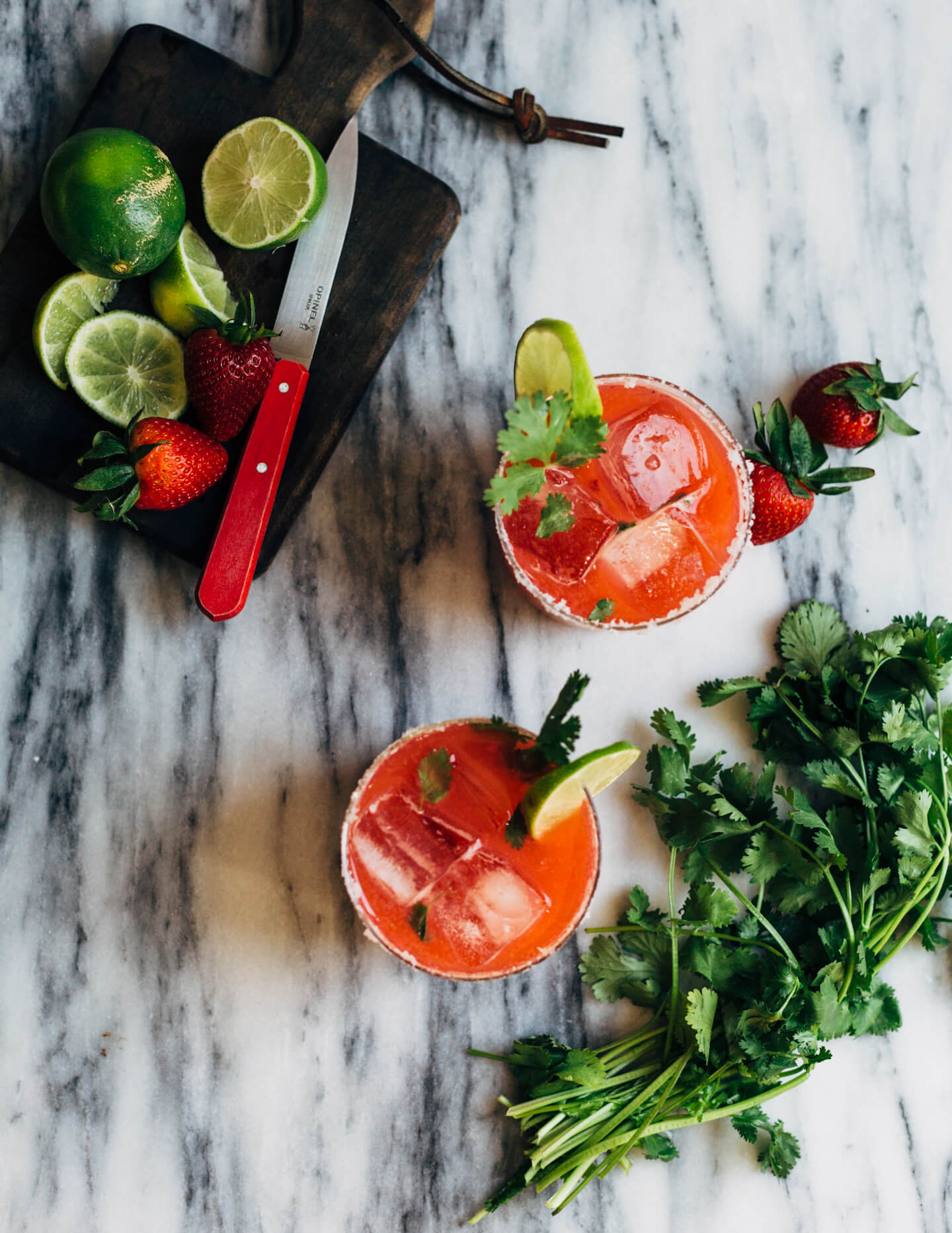 Pretty pink strawberry margaritas blended with an herbaceous cilantro, coriander, and black pepper simple syrup. These fresh strawberry margaritas are beautifully balanced and totally refreshing. 