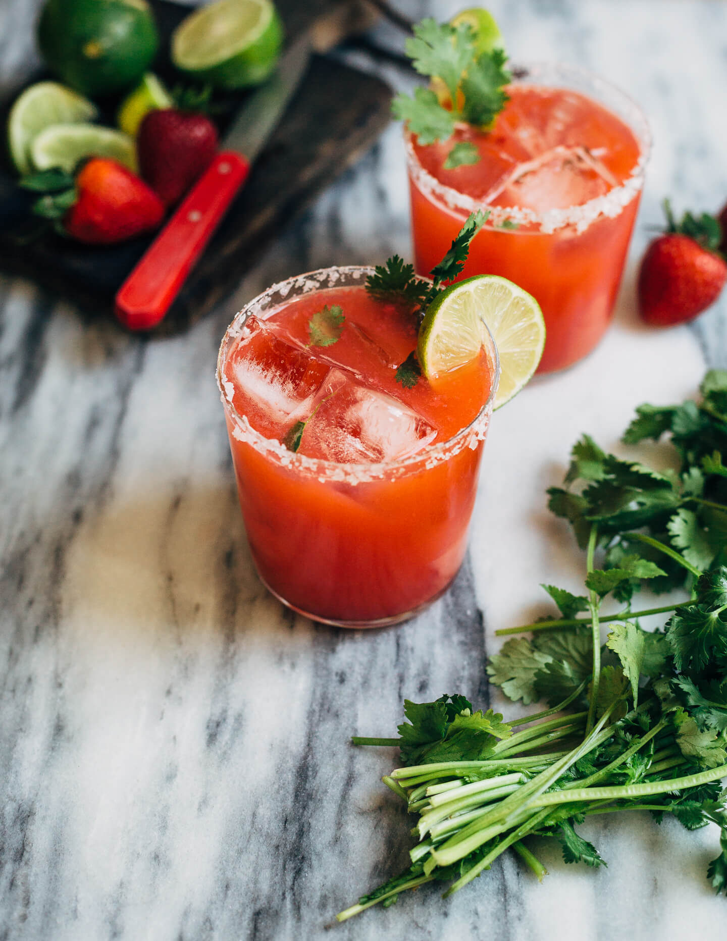 Pretty pink strawberry margaritas blended with an herbaceous cilantro, coriander, and black pepper simple syrup. These fresh strawberry margaritas are beautifully balanced and totally refreshing. 