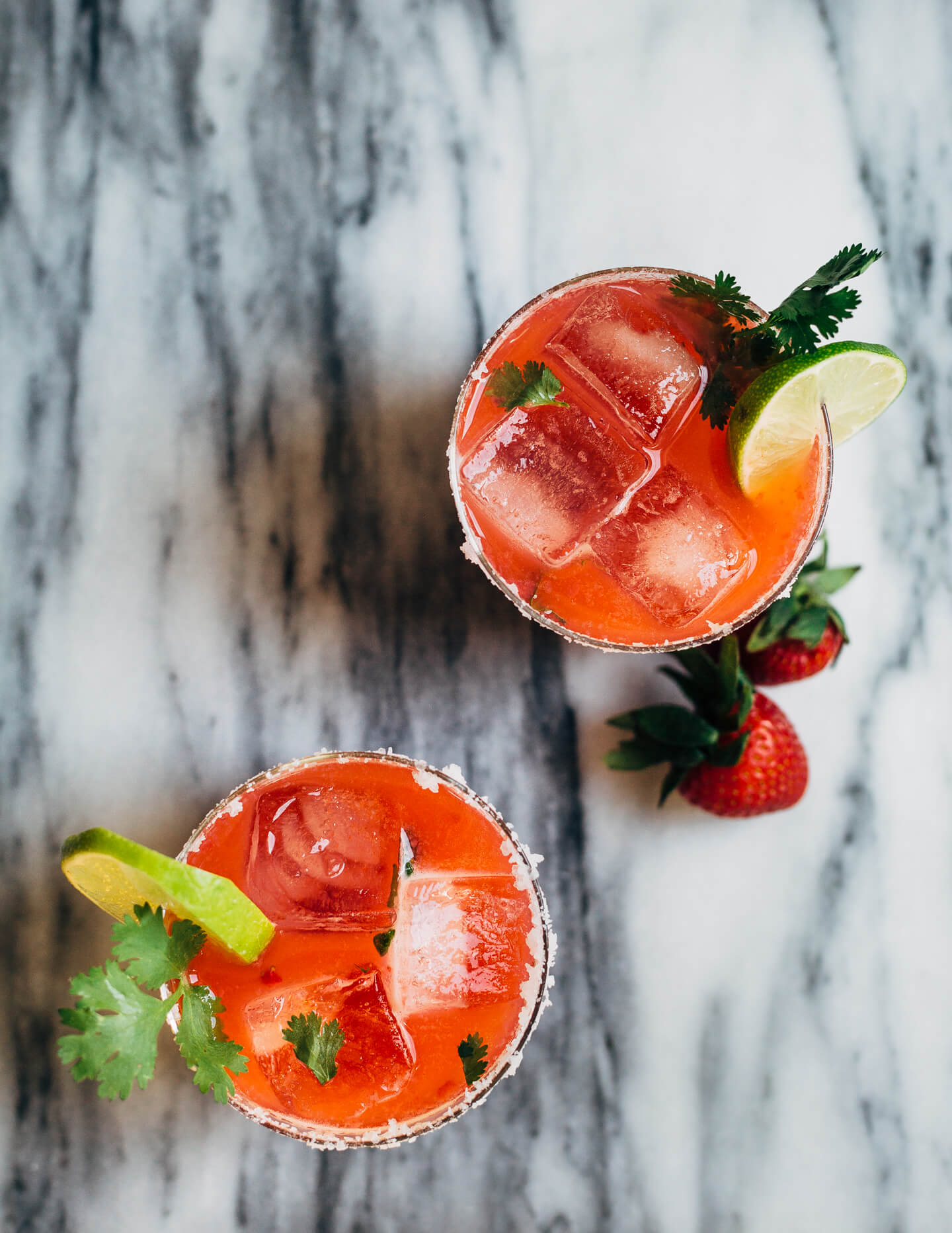 Pretty pink strawberry margaritas blended with an herbaceous cilantro, coriander, and black pepper simple syrup. These fresh strawberry margaritas are beautifully balanced and totally refreshing. 