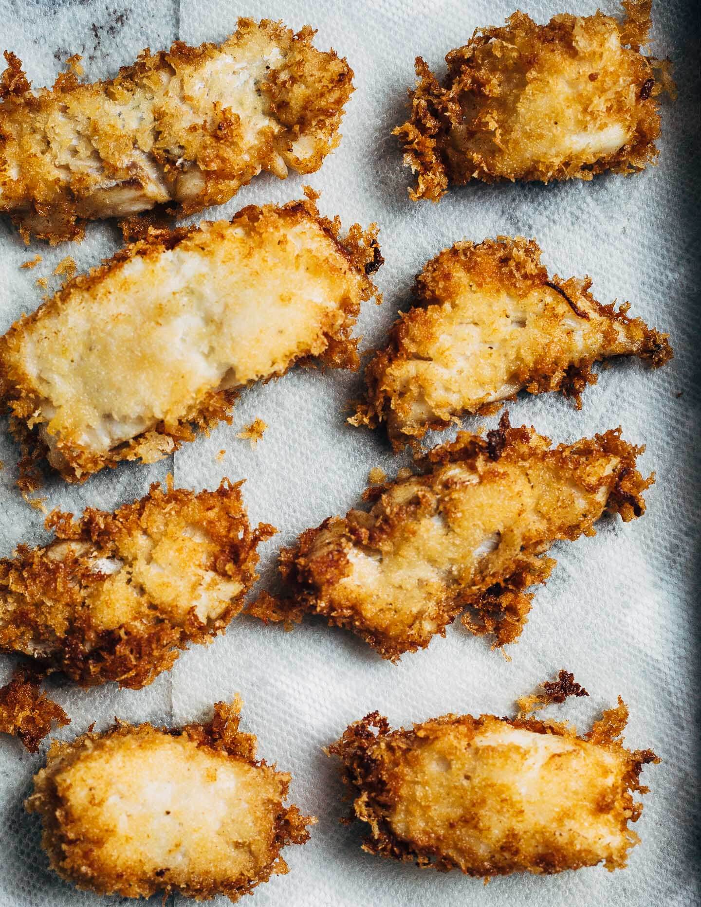 Panko-crusted fried fish sandwiches that are just right for a weeknight at home or a crowd-pleasing feast. Served with a simple radish slaw and bread and butter pickles, these flaky fish sandwiches hit all the right notes.