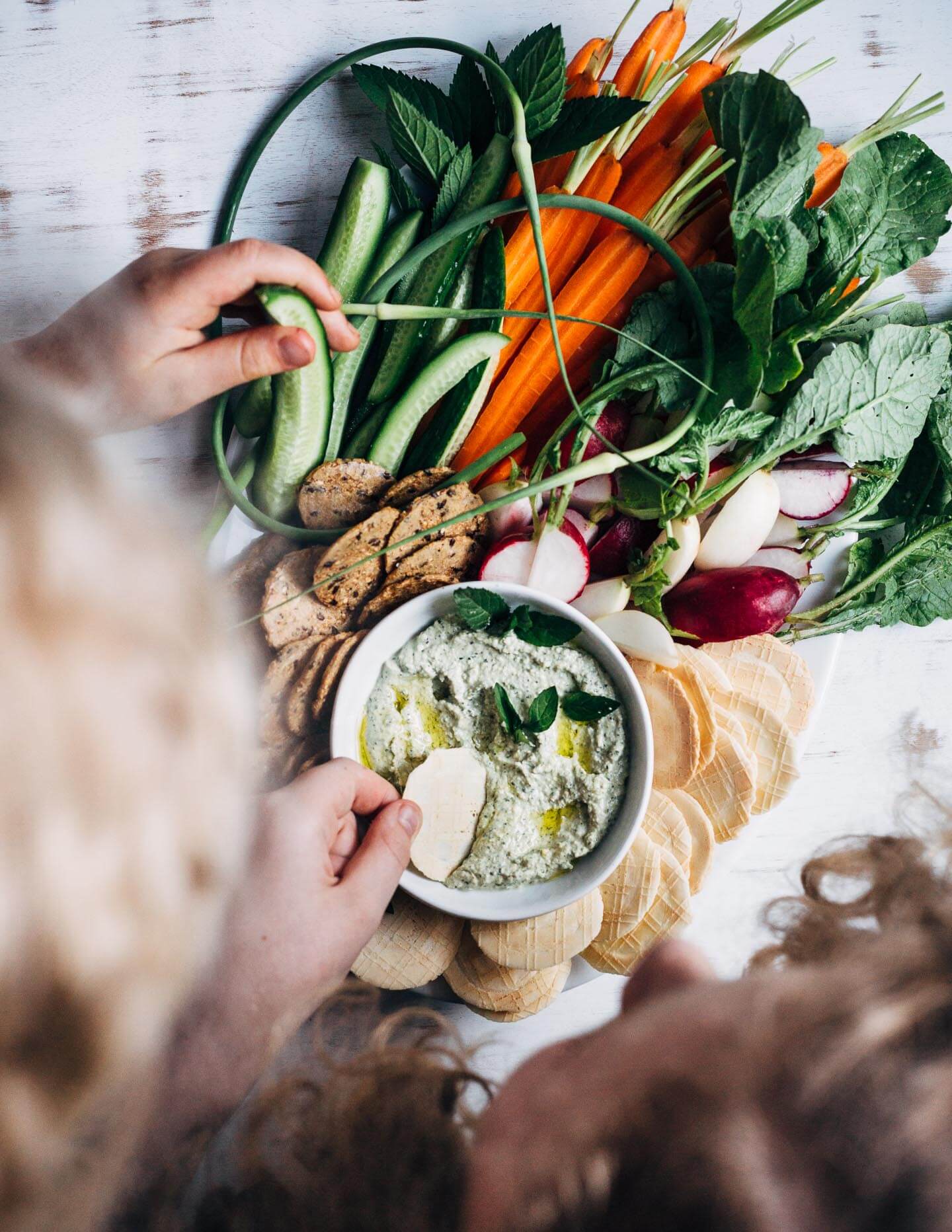 This lemony labneh and garlic scape dip is a wonderfully simple appetizer for warm weather fêtes. Creamy labneh, blended with sautéed garlic scapes, fresh mint leaves, and lemon zest, makes for a vibrant, crowd-pleasing dip.