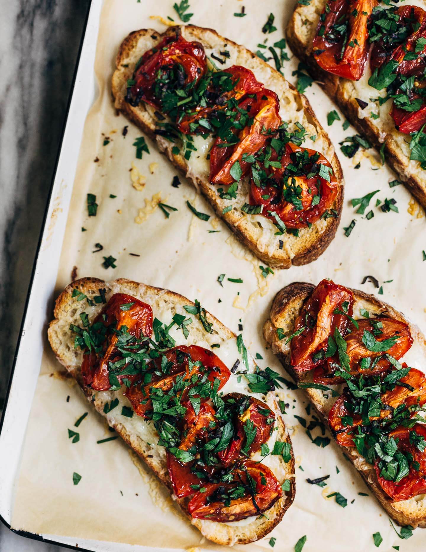 Celebrating the height of tomato season with sumptuous Gruyere and roasted tomato tartines made with thick-cut sourdough and punchy garlic butter.