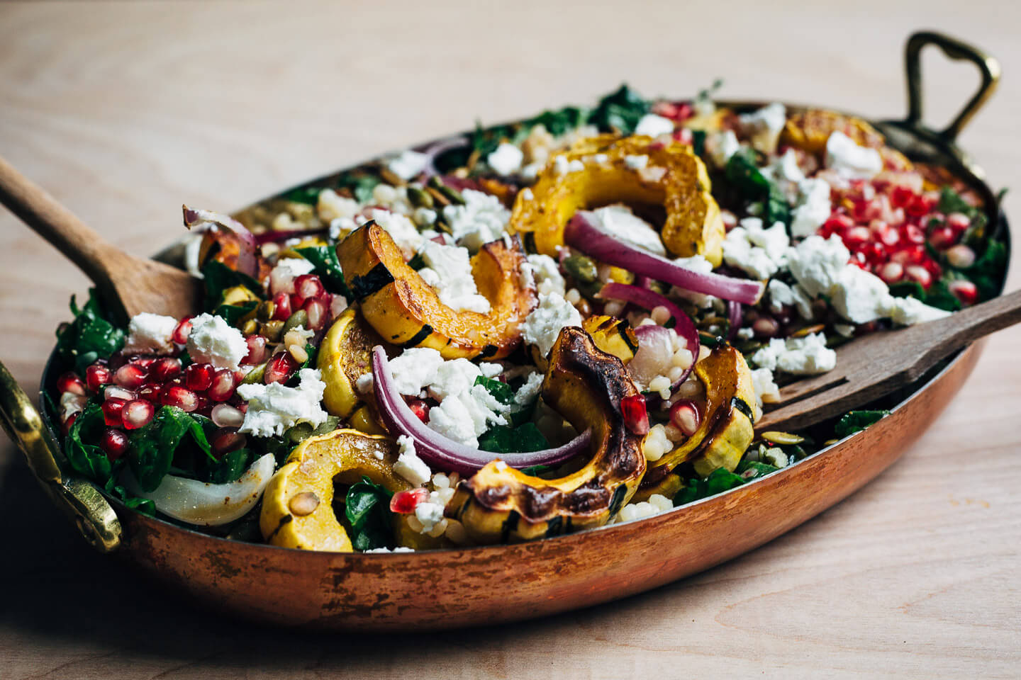 A vibrant, yet sturdy, pearl couscous and roasted delicata squash salad, tossed with tender kale, pomegranate arils, pepitas, and crumbled goat cheese, that's perfect as autumnal side dish or a versatile meal prep lunch. 