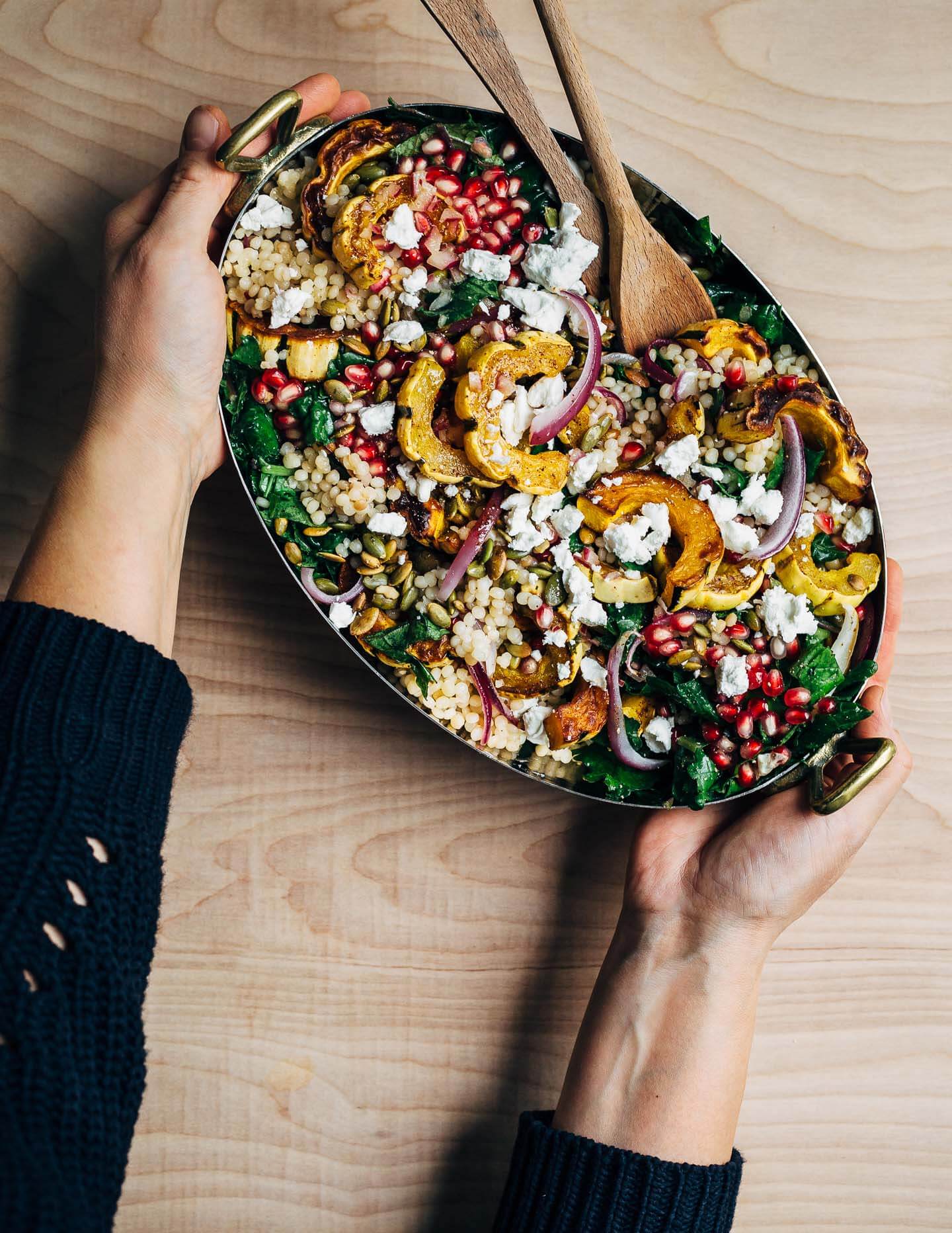 A vibrant, yet sturdy, pearl couscous and roasted delicata squash salad, tossed with tender kale, pomegranate arils, pepitas, and crumbled goat cheese, that's perfect as autumnal side dish or a versatile meal prep lunch. 