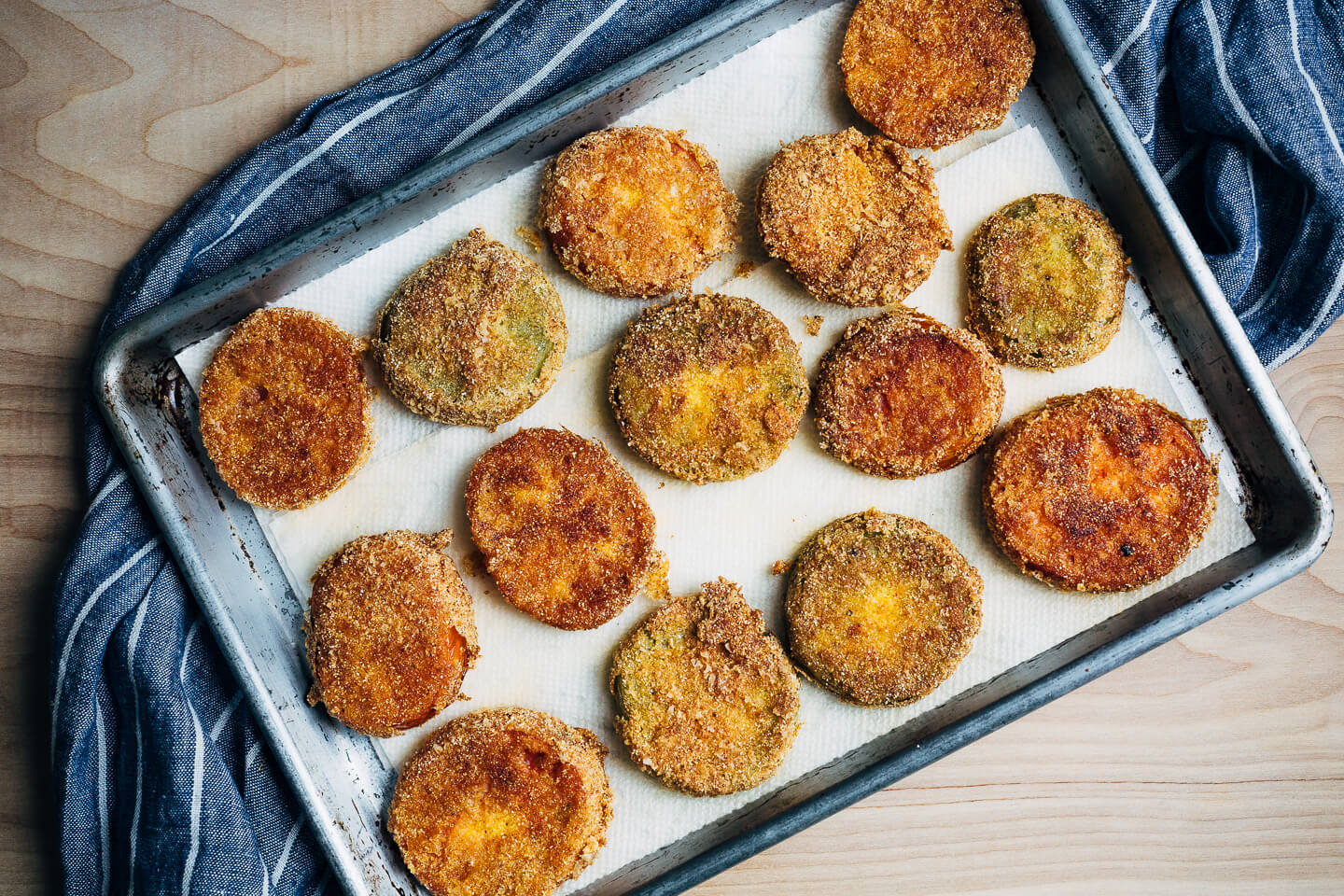 Putting leftover green tomatoes to good use with a recipe for crisp, savory fried green tomatoes topped with garlicky sautéed shrimp and a super simple remoulade.
