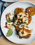 Putting leftover green tomatoes to good use with a recipe for crisp, savory fried green tomatoes topped with garlicky sautéed shrimp and a super simple remoulade.