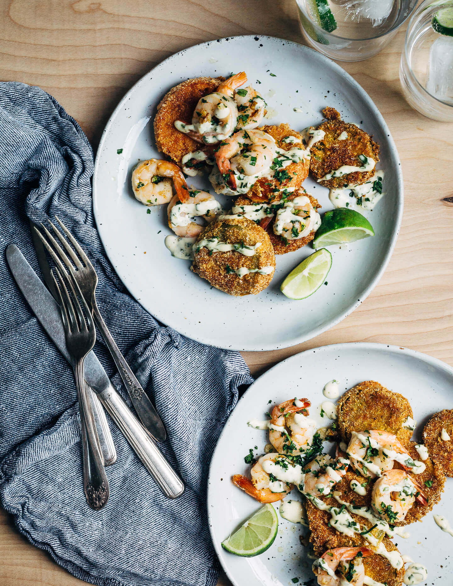 Putting leftover green tomatoes to good use with a recipe for crisp, savory fried green tomatoes topped with garlicky sautéed shrimp and a super simple remoulade.