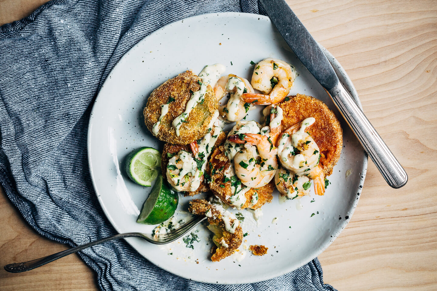 Putting leftover green tomatoes to good use with a recipe for crisp, savory fried green tomatoes topped with garlicky sautéed shrimp and a super simple remoulade.