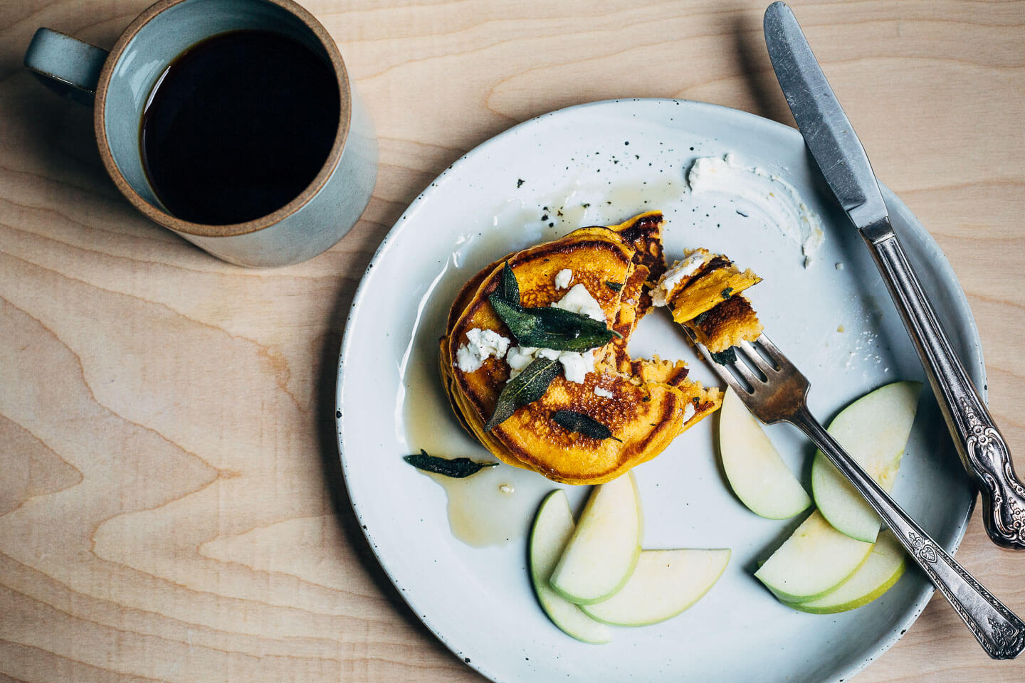 An autumnal sweet potato pancake recipe topped with fried sage leaves and crumbled goat cheese.