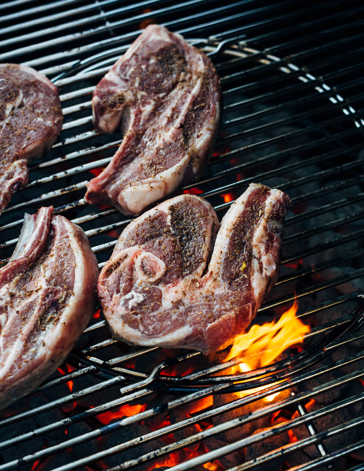 Add a pop of char and smoke to your Thanksgiving feast with this recipe for cumin-rubbed grilled lamb chops, grilled acorn squash wedges, dill and fennel tzatziki, and pomegranate arils. 