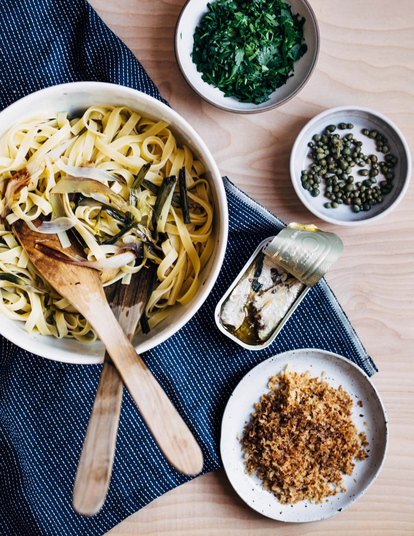A hearty dish for early spring that's at once briny, rich, and herbaceous. Fettuccine noodles are tossed with delicate roasted spring onions, capers, herbs, tinned sardines, and buttery panko for a meal that's deeply satisfying. 