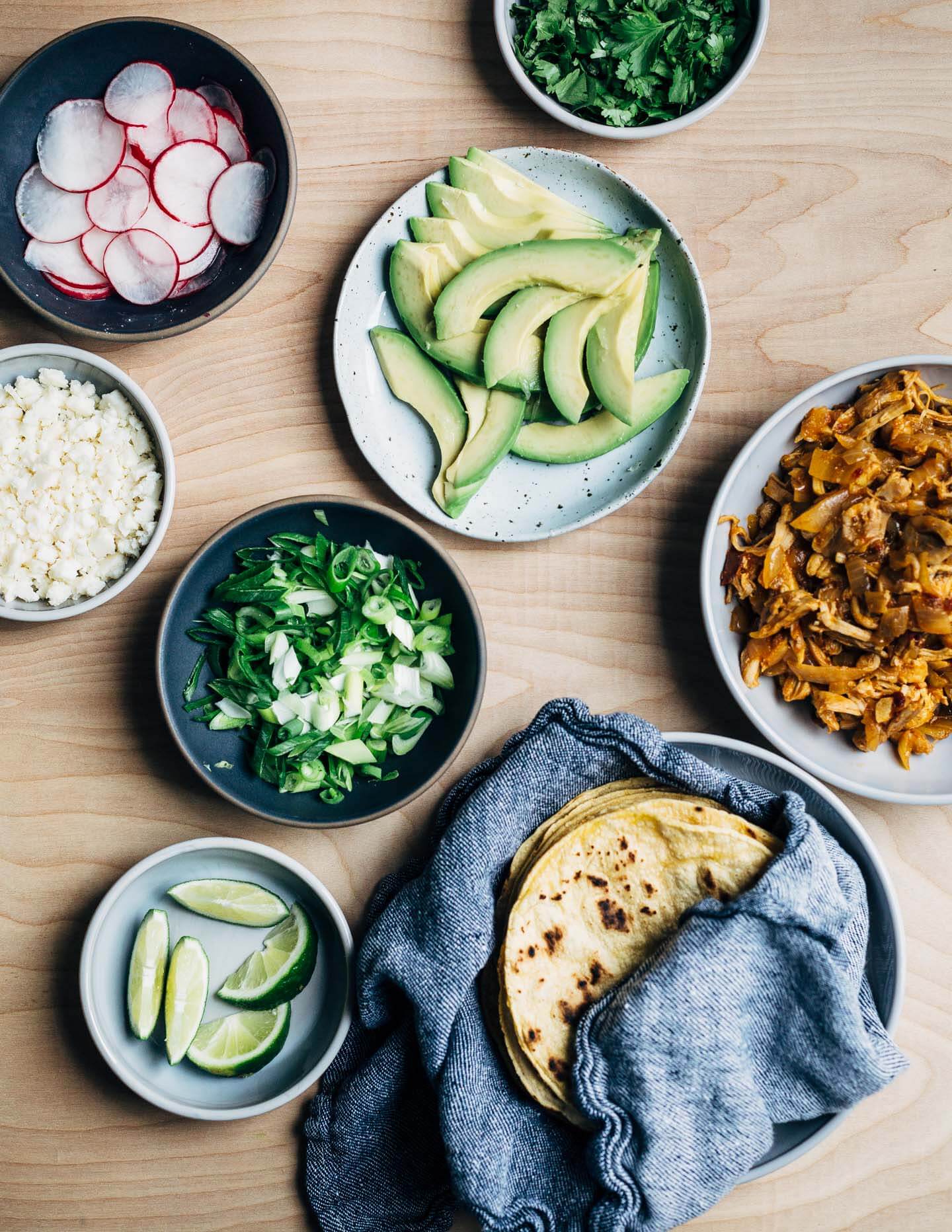 Chipotle chilies in adobo sauce lend smoky heat to these classic chicken tacos topped with avocado, radish, cilantro, and crumbled cotija. This post was created in partnership with SVO Farmer Focus Chicken. 