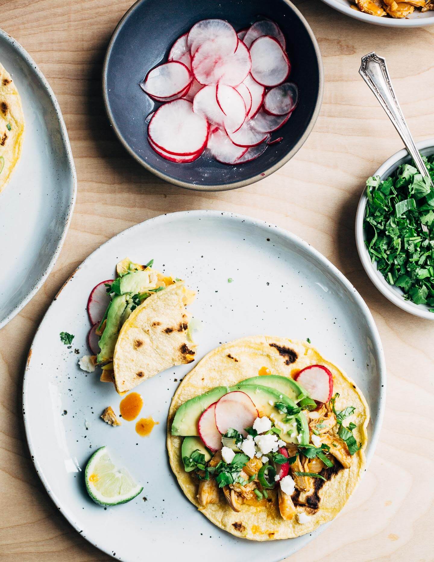 Chipotle chilies in adobo sauce lend smoky heat to these classic chicken tacos topped with avocado, radish, cilantro, and crumbled cotija. This post was created in partnership with SVO Farmer Focus Chicken. 