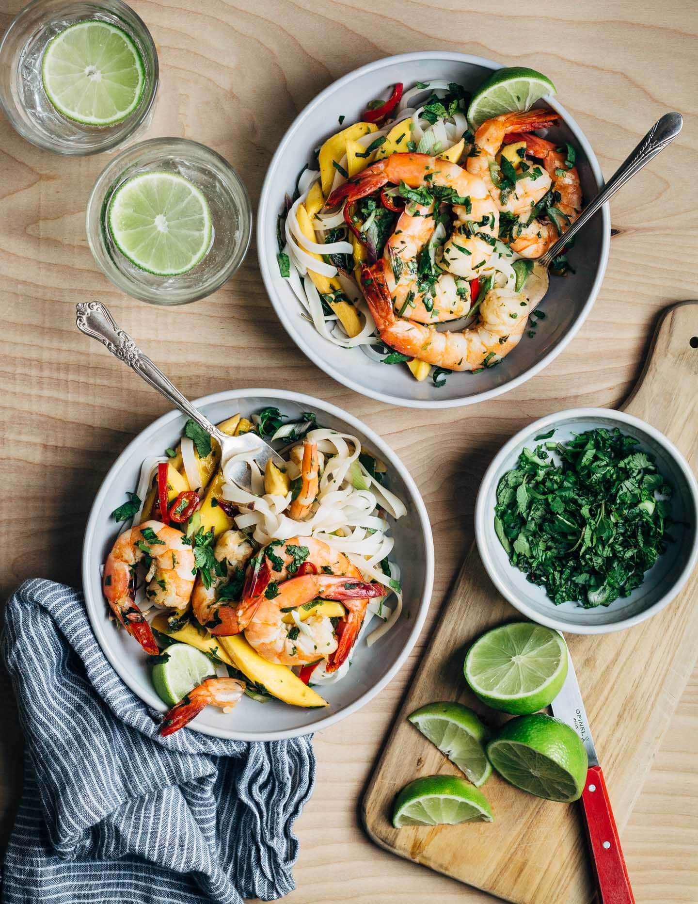 Fresh sliced mango and shrimp seared in coconut oil tossed with chilis, herbs, rice noodles, and a simple lime sauce makes for a nearly effortless, crazy flavorful weeknight meal.