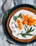 A simple olive oil carrot cake for spring celebrations! The tender, springy whole wheat crumb is suffused with nutty olive oil, fresh carrots, and orange zest. The cake is topped with an airy, lightly sweet yogurt and cream cheese frosting, carrot ribbons, tarragon, and edible flowers. 