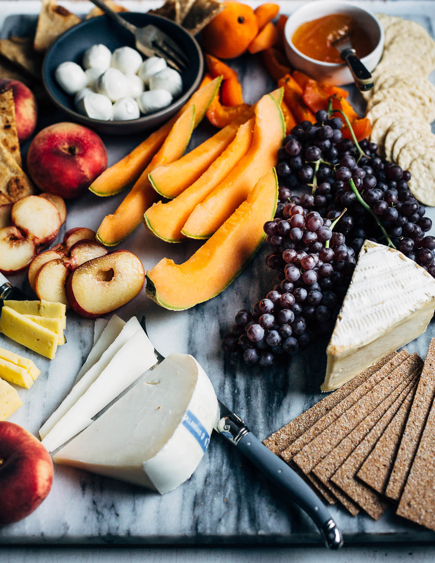 A seasonal summer fruit and cheese board.