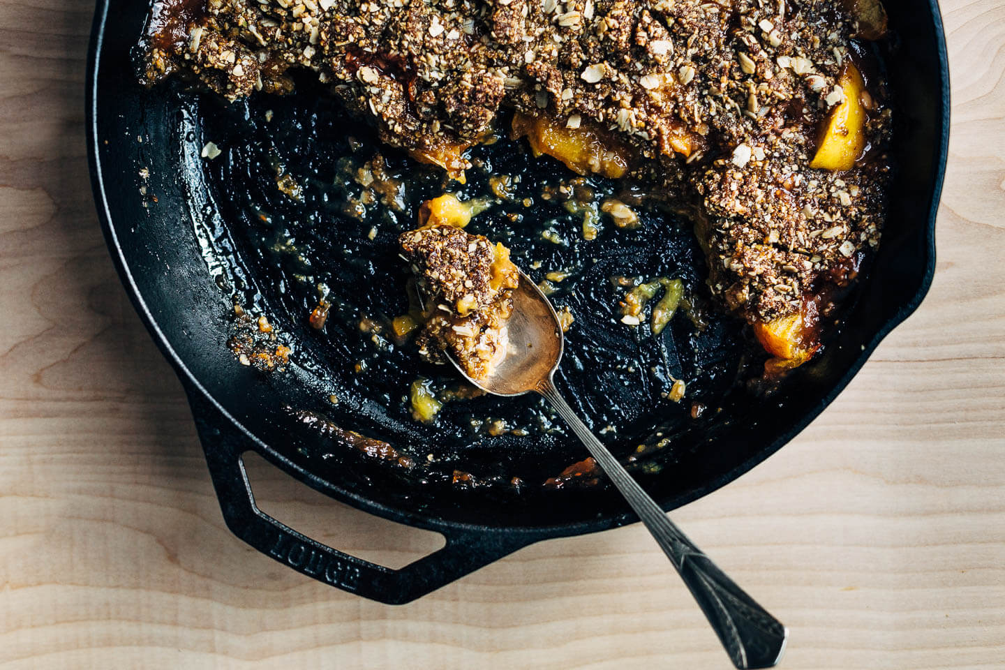 Vegan peach crumble in a cast iron skillet. 