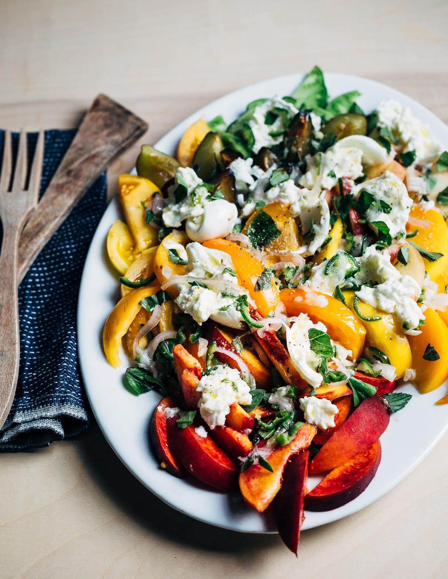 Stone fruit and tomato salad, ready to serve.