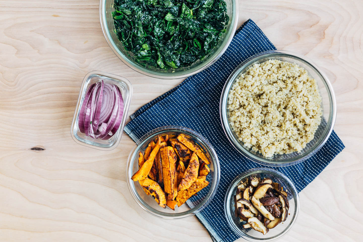 Meal prepping quinoa, kale salad, roasted butternut squash, and red onions for pizzas and quick salads. 