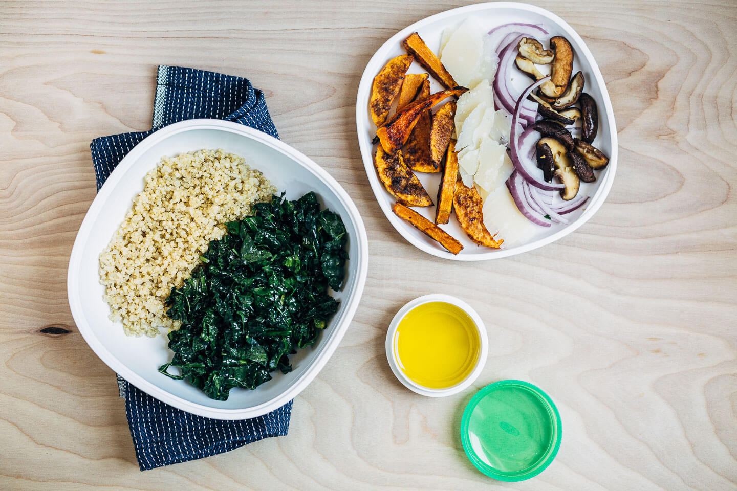 Meal prep salad elements including roasted butternut squash, mushrooms, Parmesan, kale, and quinoa. 