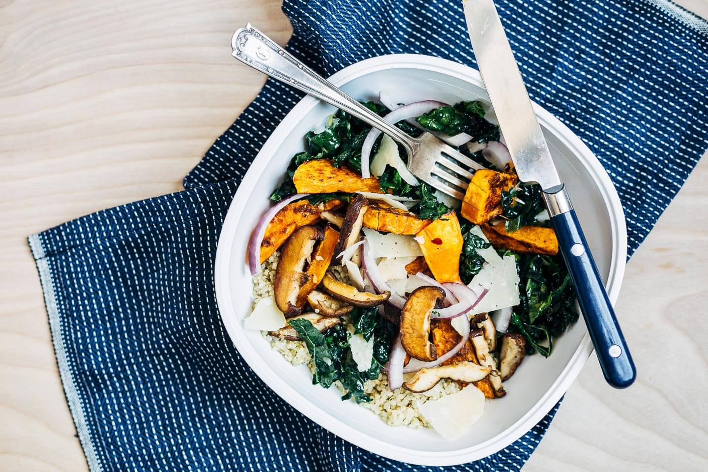 A not sad desk lunch featuring a roasted butternut squash, kale, and quinoa salad. 