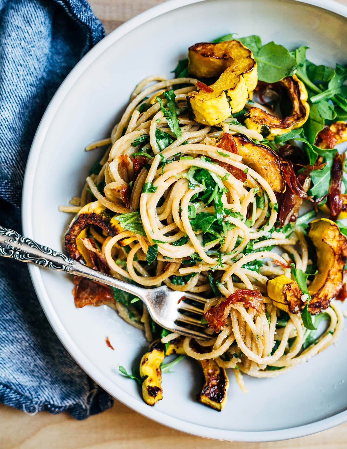 Al dente whole wheat spaghetti with Parmesan sauce, roasted delicata squash, and crispy speck. 