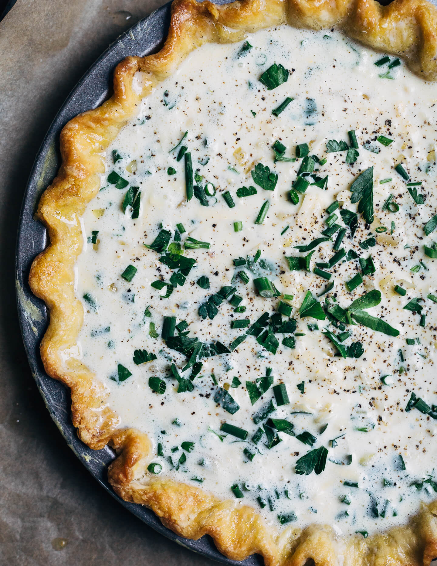 Sharp cheedar quiche with fresh chives, heading to the oven.