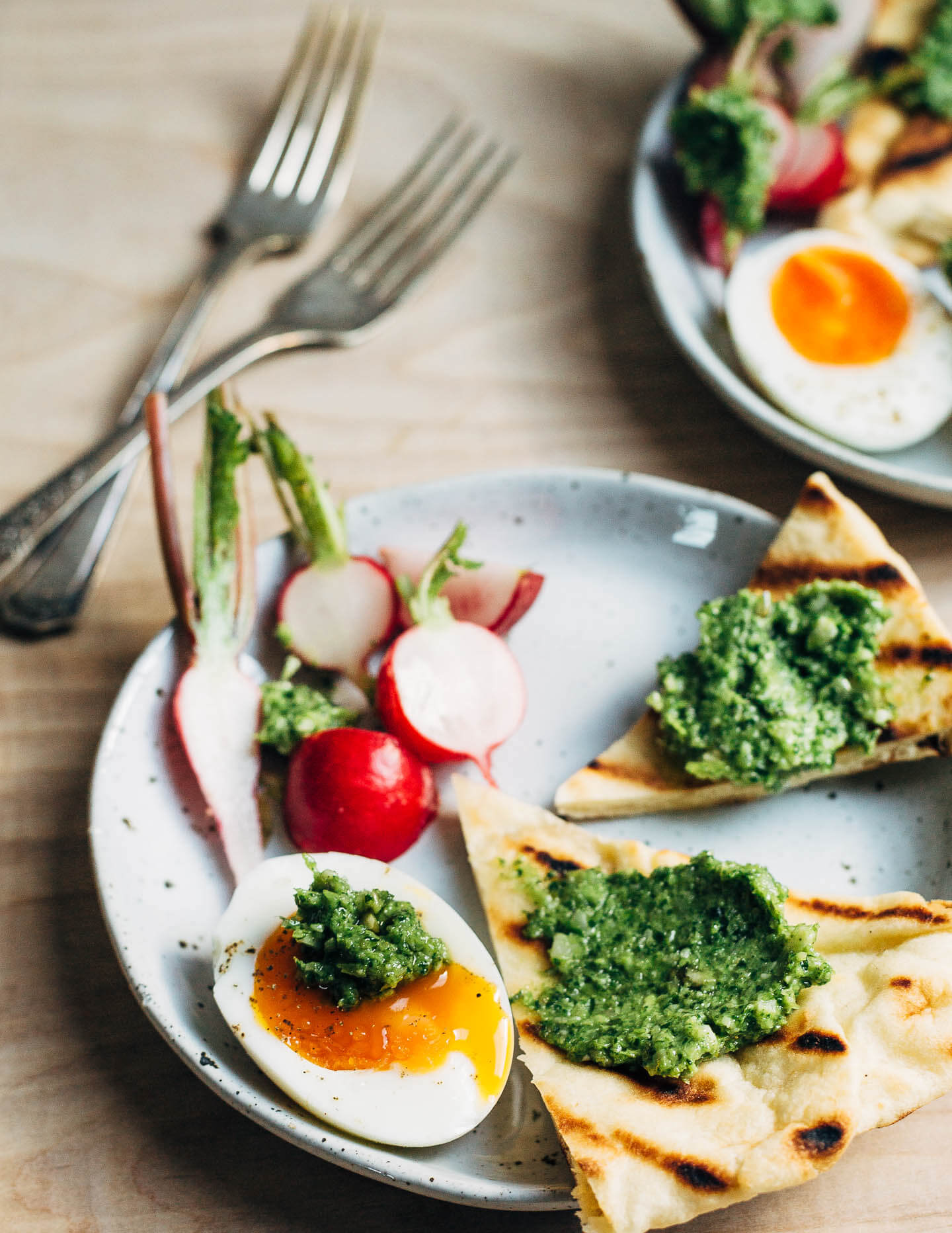 Green garlic pesto smeared on grilled naan and jammy eggs.
