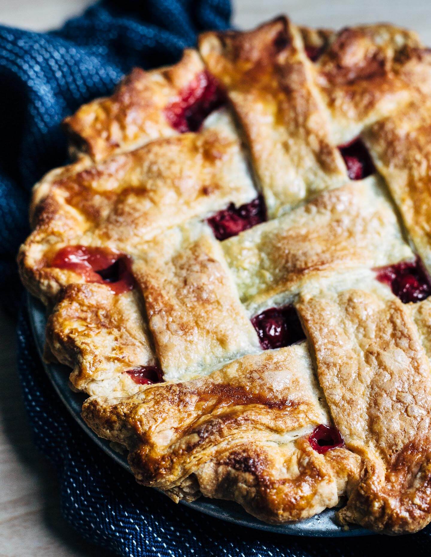 Lattice top sour cherry pie with a flaky, all butter crust, just out of the oven.