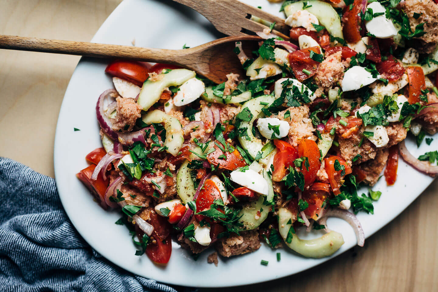 A classic summer salad, this panzanella with mozzarella and herbs features perfectly ripe summer tomatoes, a punchy garlic and anchovy vinaigrette.