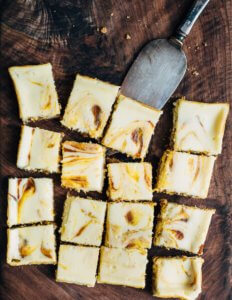 A cutting board with slice dessert bars.