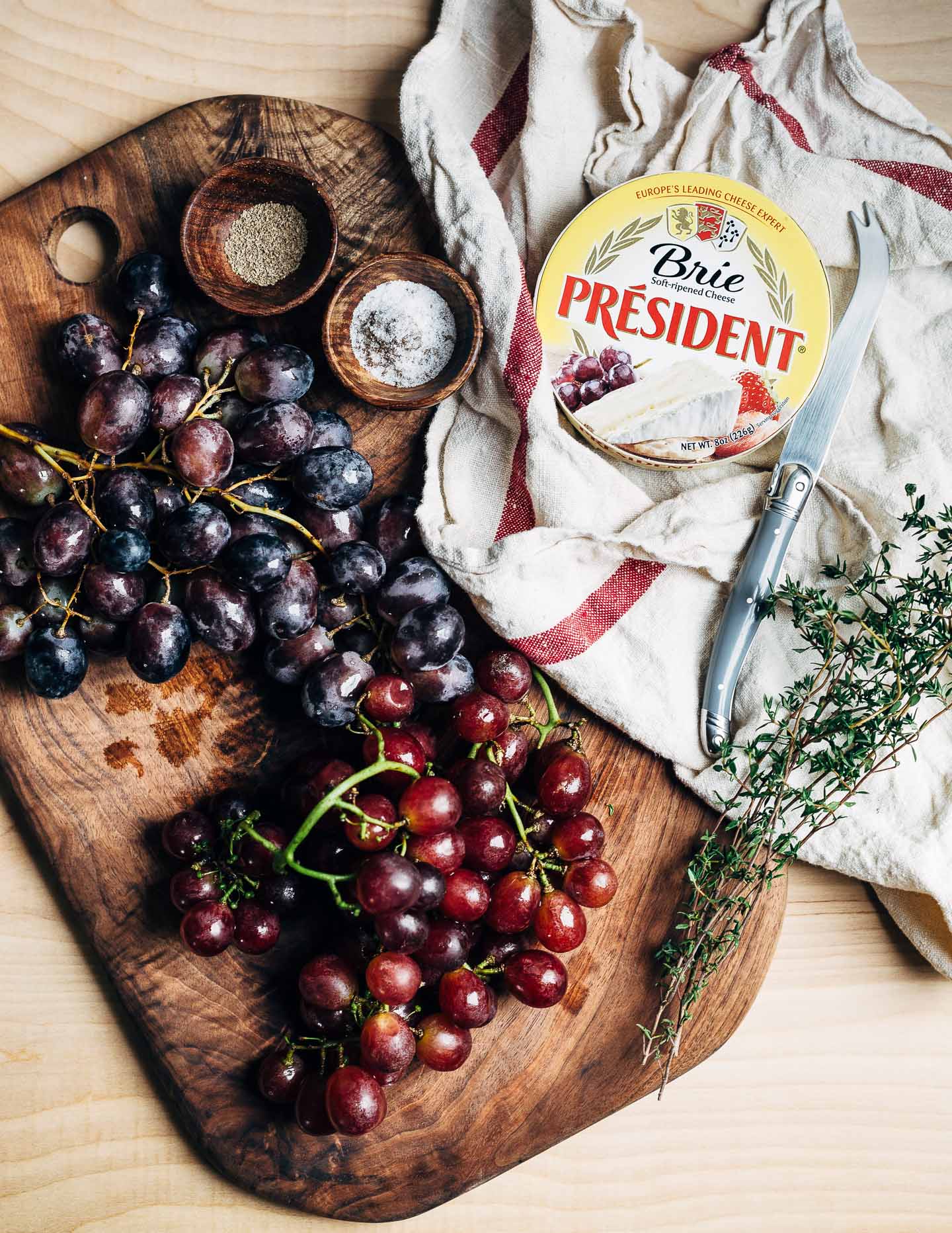 Black and red grapes, fresh thyme, and President brie.