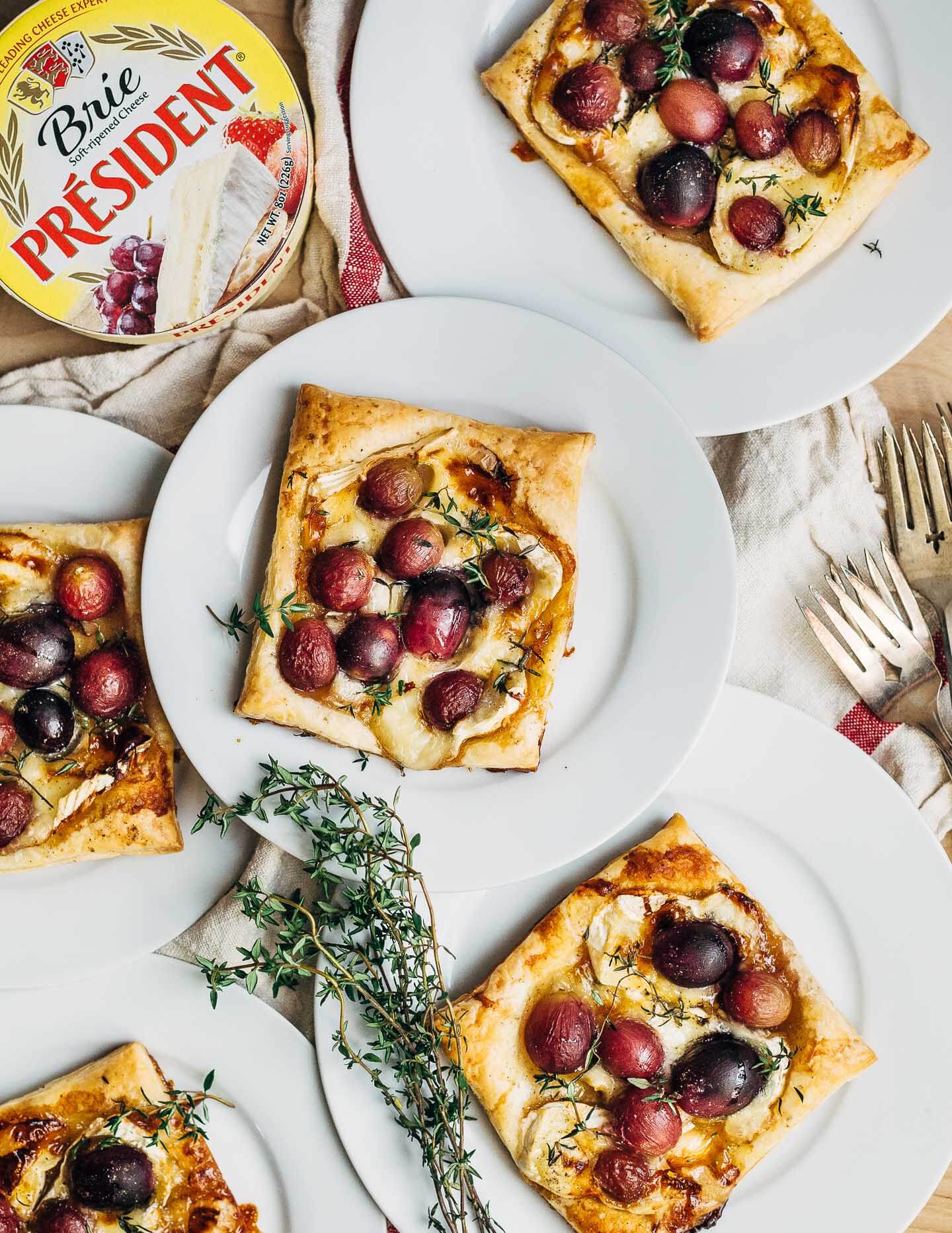 Brie and roasted grape tarts, plated and ready to serve.