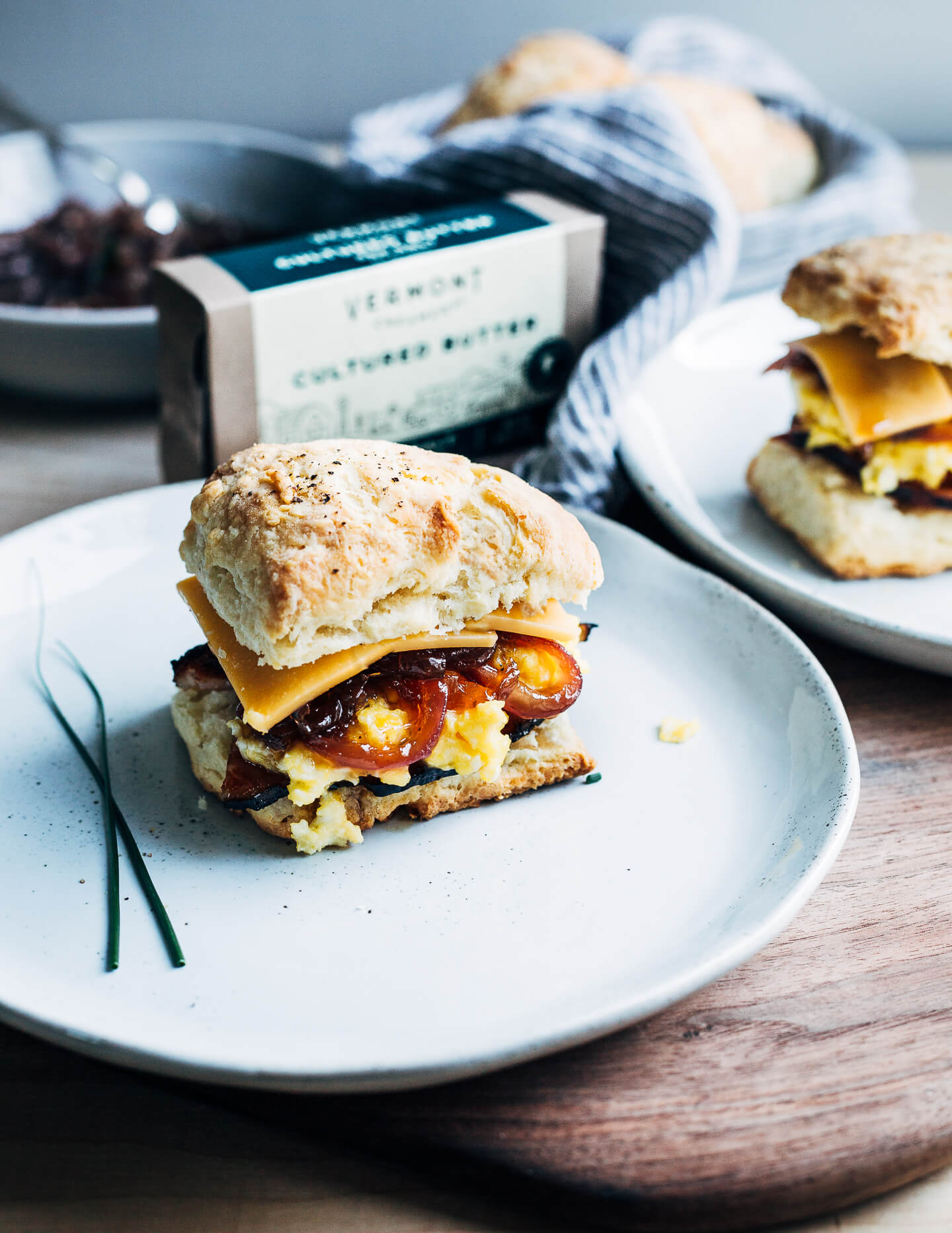 Perfect for a relaxed weekend or a holiday brunch, these layered biscuit sandwiches begin with airy homemade biscuits and are topped with thick-cut ham, slow-scrambled eggs, sharp cheddar, and a quick red onion jam.