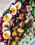This winter Nicoise-ish salad hits all the right notes with crunchy shaved fennel and radishes, greens and radicchio, tender new potatoes suffused with herbs and a punchy vinaigrette, just-set 7-minute steamed eggs, and piles of olives.